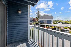 Renton apartment for rent - A balcony with a view of a parking lot and a building.