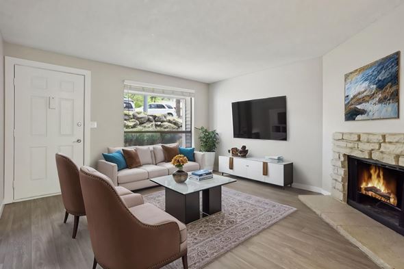 Federal Way apartment for rent - A living room with a fireplace and a television on the wall.