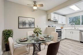 Federal Way apartment for rent - A modern dining room with a glass table and chairs.