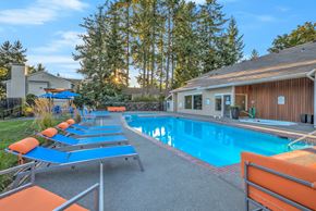 Renton apartment for rent - A pool with sun loungers and a building in the background.
