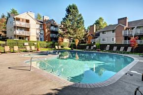 Kent apartment for rent - A swimming pool surrounded by a fence and buildings.