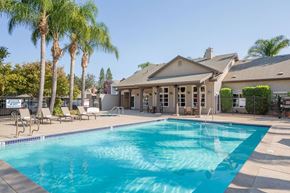 Woodland apartment for rent - A large house with a pool in front.