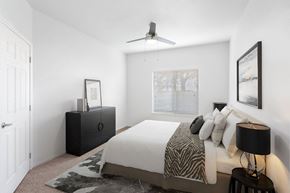Woodland apartment for rent - A bedroom with a bed, a dresser, and a ceiling fan.