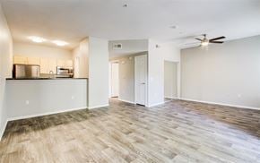 Gilbert apartment for rent - A spacious room with a wood floor and a ceiling fan.