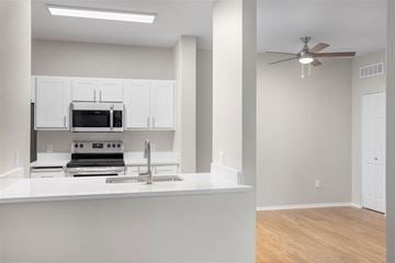Gilbert apartment for rent - A modern kitchen with white cabinets and a stainless steel oven.