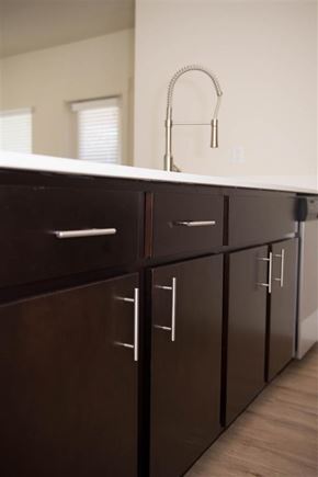 Stockton apartment for rent - A kitchen with brown cabinets and a white counter.