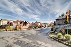 Olympia apartment for rent - A street view of a residential area with houses and a sign that reads "WORLDAN".