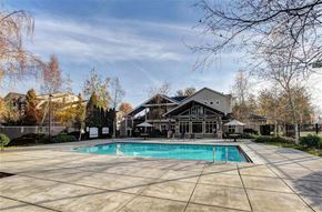Puyallup apartment for rent - A large house with a pool in the backyard.