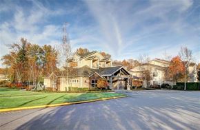 Puyallup apartment for rent - A large, well-maintained building with a spacious driveway in front.