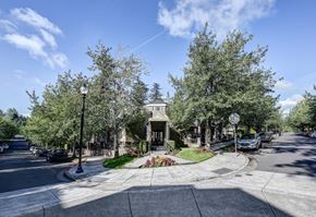 Gresham apartment for rent - A street view of a residential area with houses and trees.