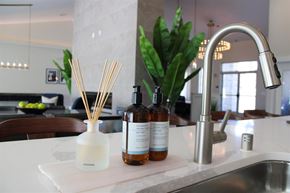 Stockton apartment for rent - A kitchen counter with a sink, a diffuser, and two bottles of diffuser oil.