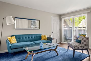 Portland apartment for rent - A living room with a blue couch and a glass coffee table.