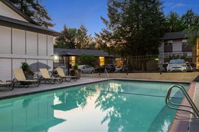 Portland apartment for rent - A pool with a metal ladder and a few chairs.