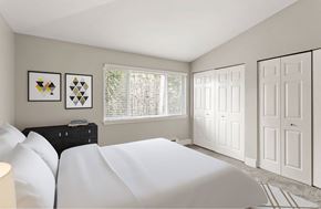 Tumwater apartment for rent - A bedroom with a white bed and two framed pictures on the wall.