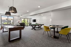 Fort Worth apartment for rent - A room with a pool table, ping pong table, and a TV.