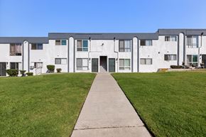 National City apartment for rent - A long white building with a walkway in front.