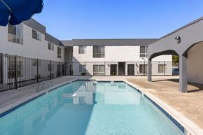National City apartment for rent - A swimming pool is located in the middle of a courtyard.