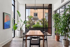 Austin apartment for rent - A dining room with a table and chairs and a potted plant.