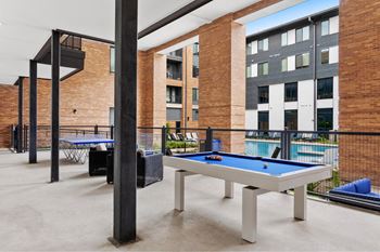 Shaded outdoor pool table fire pit and lawn