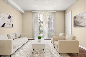 Austin apartment for rent - A living room with a white couch, two chairs and a coffee table.