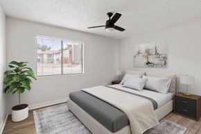 Austin apartment for rent - A bedroom with a bed, nightstand, and a plant.