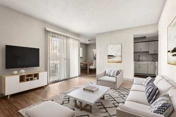 Austin apartment for rent - A modern living room with a white sofa and a wooden entertainment center.