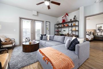 Midland apartment for rent - A living room with a grey couch and a wooden coffee table.