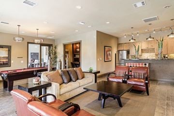 Odessa apartment for rent - A living room with a pool table and leather chairs.