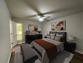 Raleigh apartment for rent - A bedroom with a bed, nightstand, and a ceiling fan.