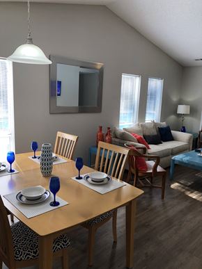 Raleigh apartment for rent - A dining room with a wooden table set for two.
