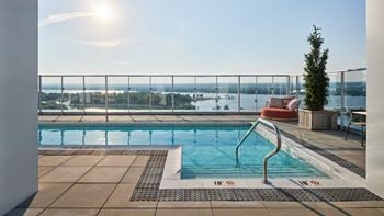 A sunny day at the pool with a view of the city.