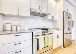 Gatineau apartment for rent - A kitchen with white cabinets and a stainless steel stove.