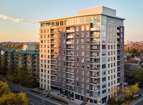 Ottawa apartment for rent - A tall apartment building with many windows and balconies is shown from an aerial perspective.
