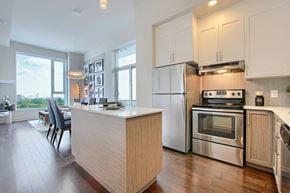Ottawa apartment for rent - A modern kitchen with a wooden island and stainless steel appliances.