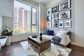 Ottawa apartment for rent - A living room with a couch, coffee table, and pictures on the wall.