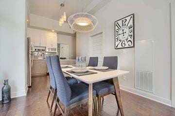 Ottawa apartment for rent - A dining room with a table set for two and a clock on the wall.