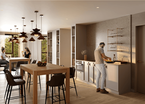 Gatineau apartment for rent - A man is cooking in a modern kitchen with a dining table and chairs.