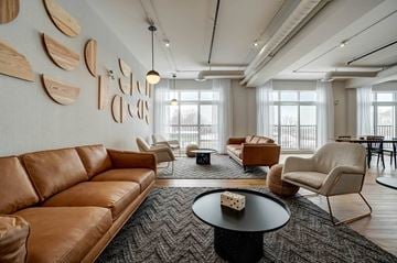 Ottawa apartment for rent - A living room with a brown leather couch and a coffee table.