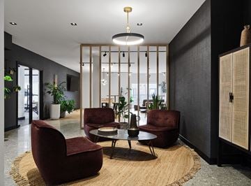 Gatineau apartment for rent - A modern living room with a large rug and a round table with four chairs.