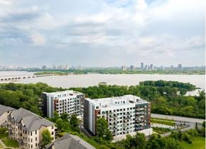 Gatineau apartment for rent - A river flows through a city with apartment buildings on both sides. at Château golf, Gatineau, QC J9H 0M9