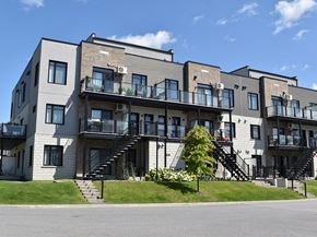 Gatineau apartment for rent - A modern apartment building with multiple balconies and staircases.