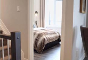 Gatineau apartment for rent - A bedroom with a bed and a chair.