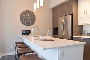 Gatineau apartment for rent - A kitchen with a white countertop and a clock on the wall.
