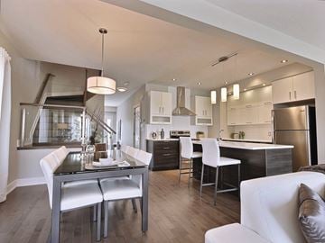 Gatineau apartment for rent - A modern kitchen with a dining table and chairs.
