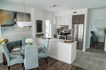 Ottawa apartment for rent - A modern kitchen with a dining table set for four.