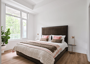 Ottawa apartment for rent - A bedroom with a large bed and a potted plant at Petries Landing I Apartments , Ontario, K4A 1K4