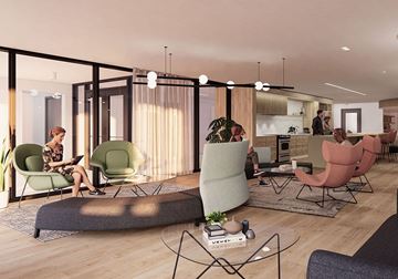 Ottawa apartment for rent - A woman is sitting on a green chair in a modern living room.