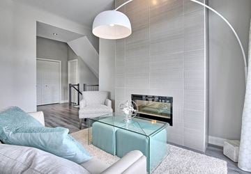 Gatineau apartment for rent - A modern living room with a white couch and a glass coffee table.