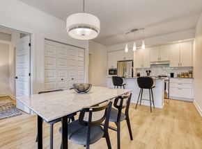 Gatineau apartment for rent - A modern kitchen with a dining table and chairs.
