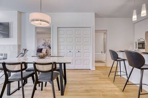 Gatineau apartment for rent - A modern dining room with a white door and a table set for four.